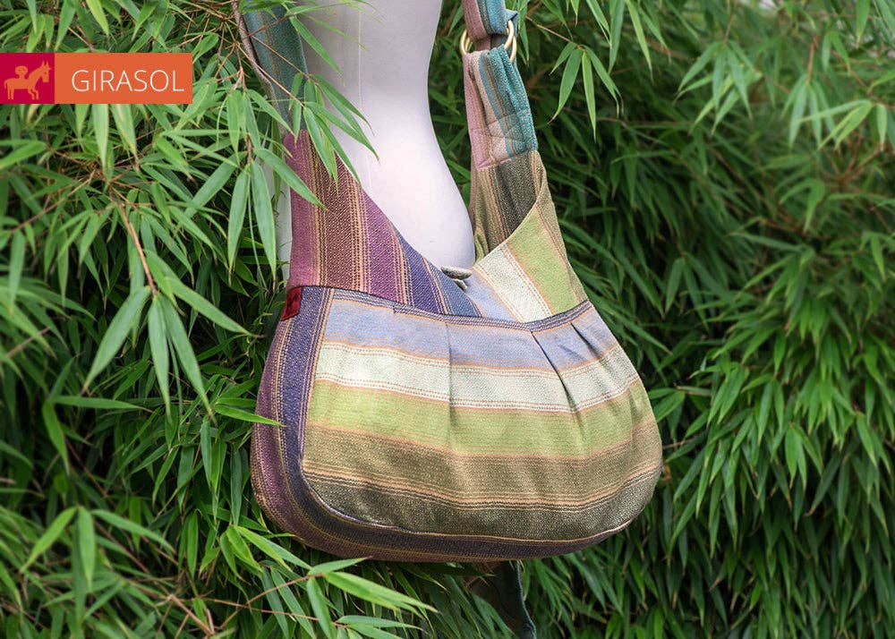 Girasol Rayos D'oro Sling Bag displayed outside in tropical shrubbery 