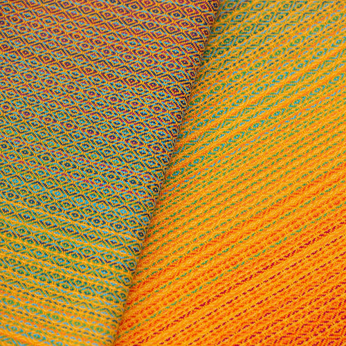 Girasol Baby Wrap Free Elf Fusion D'Oro fabric close-up — orange gold diamond weave 277gsm double weft handwoven Guatemala
