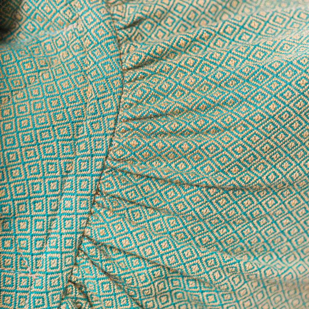 Girasol WrapMySol Lizard back view on mannequin — earthy green diamond weave half buckle Mei Tai Meh Dai