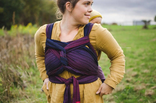 Girasol WrapMySol Twilight worn outdoors — navy purple half buckle carrier handwoven cotton Mei Tai Meh Dai newborn to toddler